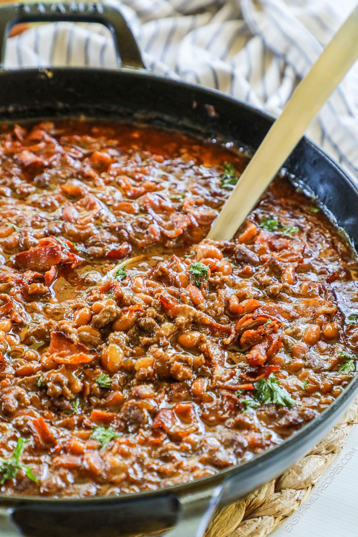 Skillet of cowboy baked beans with ground beef.