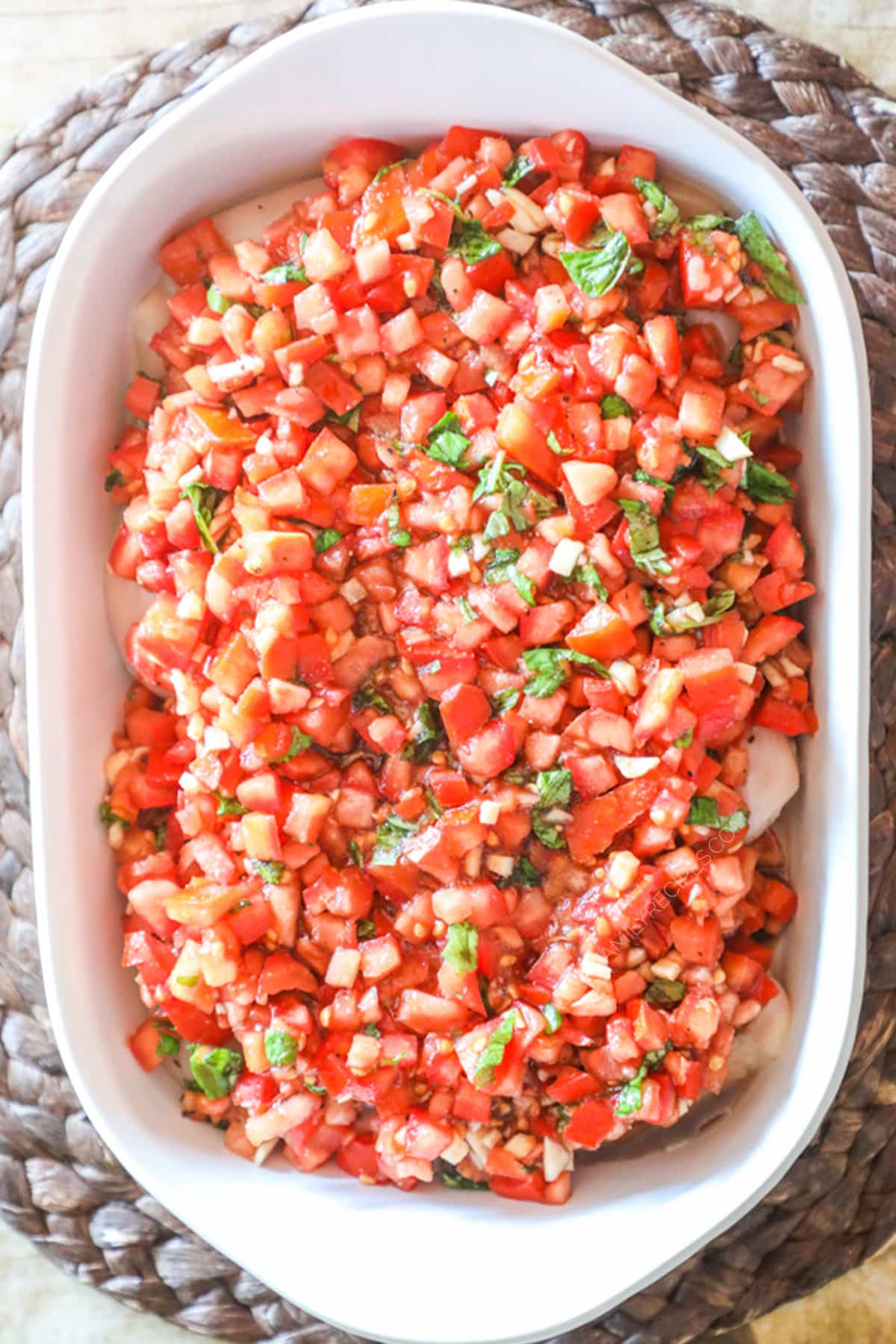 Step by Step recipe for Bruschetta Chicken Step 3. Pour tomato mixture on top of chicken and evenly spread out