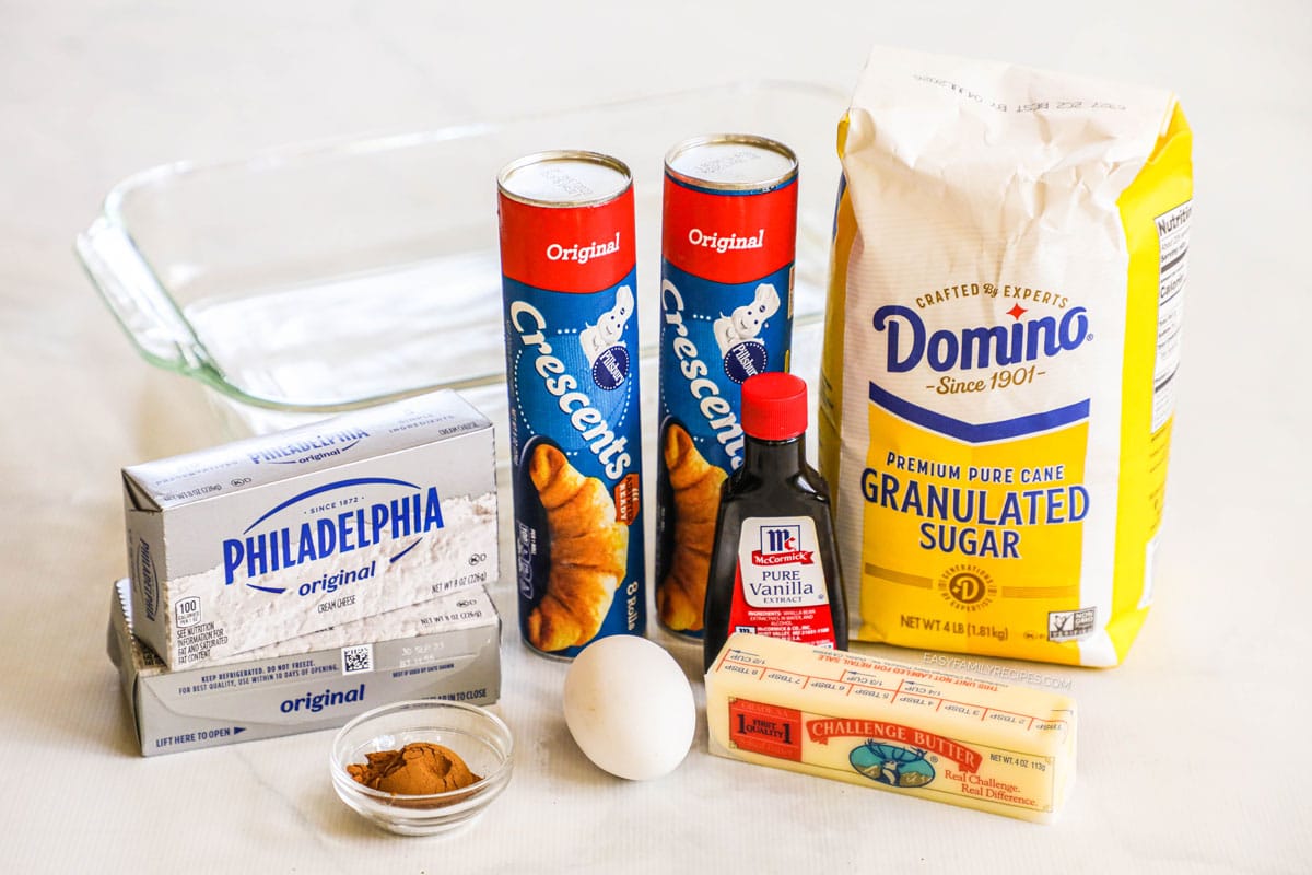 Ingredients for churro cheesecake bars: cream cheese, egg, crescent roll dough, butter, cinnamon, vanilla, sugar