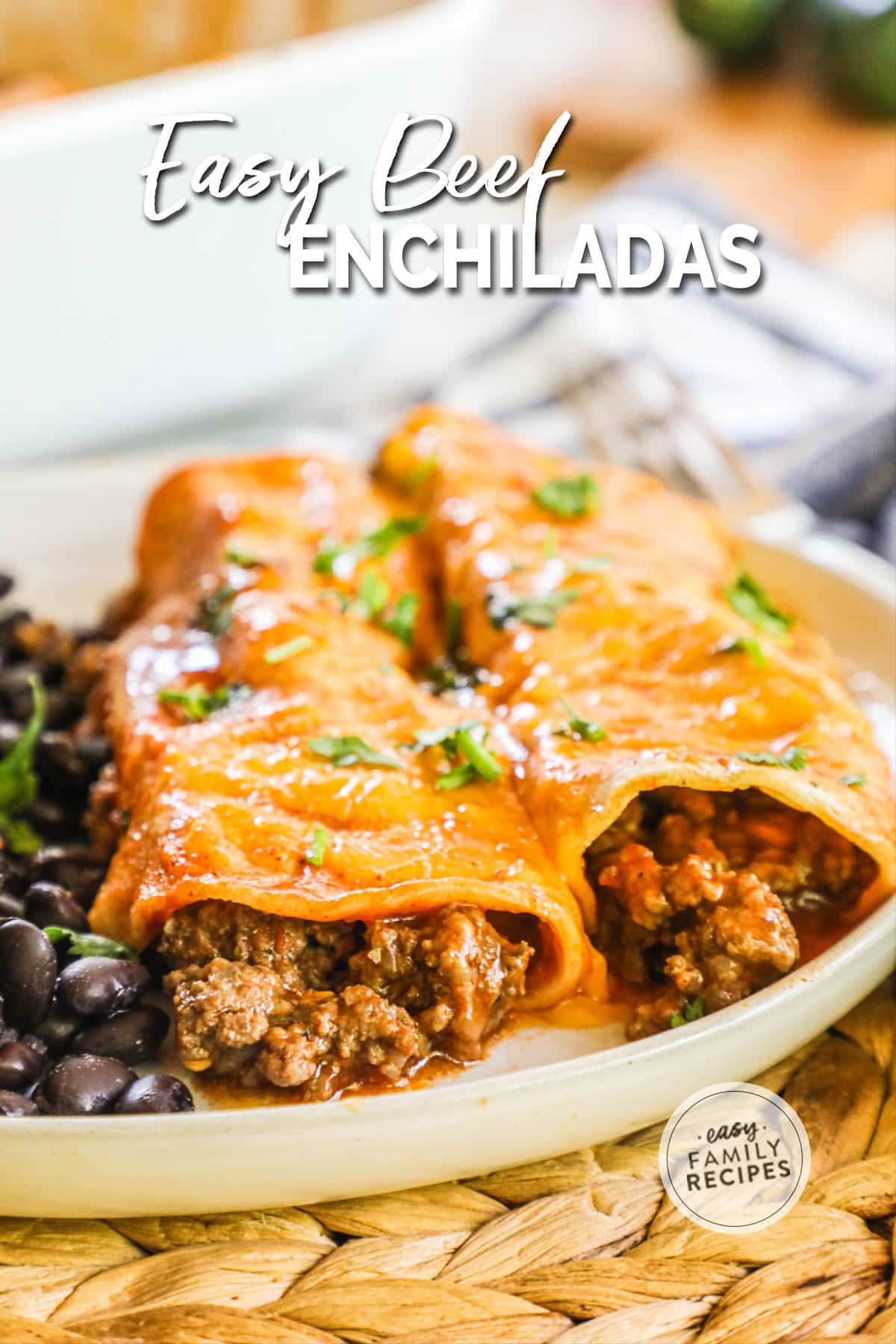 Two beef enchiladas on plate with black beans