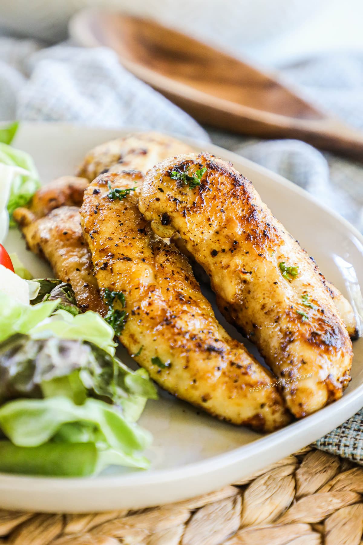 Lemon Pepper Chicken Tenders on a plate with salad.