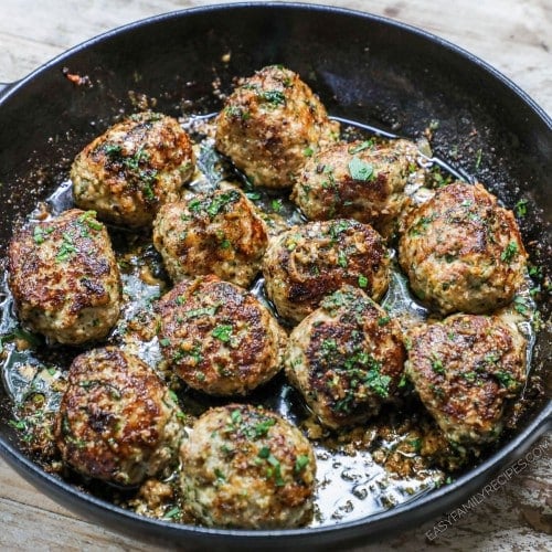 Garlic Butter Meatballs Recipe prepared in a large skillet and garnished with parsley
