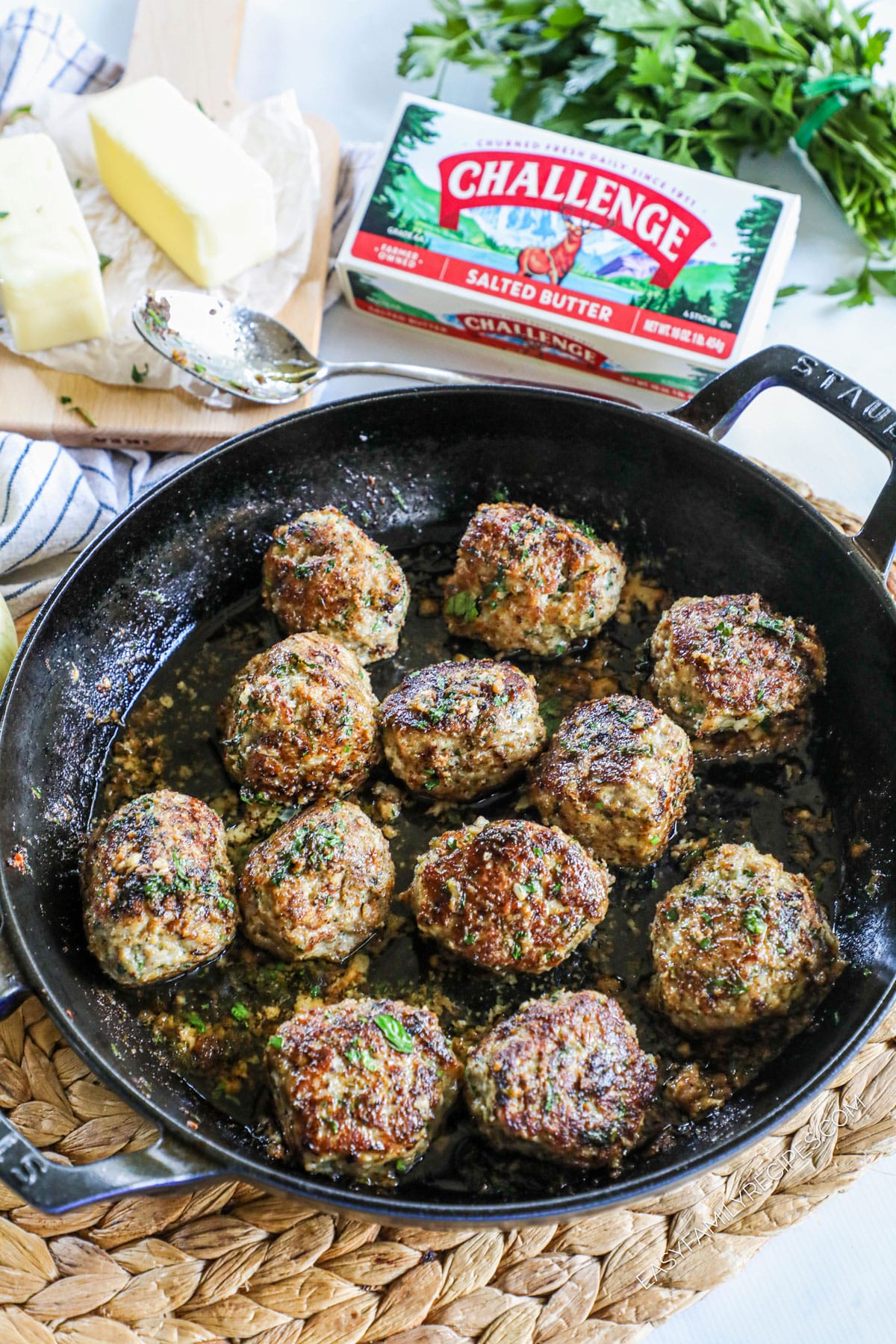 Ground Turkey Meatballs in garlic butter sauce sitting in a cast iron skillet and garnished with parsley