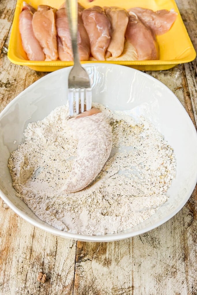 How to make Lemon Pepper Chicken Tenders Step 2: Dust the chicken tenders with the seasoned flour.