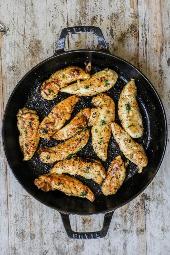 How to make Lemon Pepper Chicken Tenders Step 4: Toss the chicken tenders with lemon butter sauce.