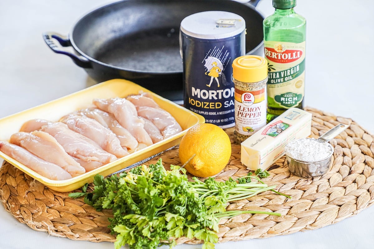 Ingredients for making Lemon Pepper Chicken Tenders including chicken tenderloins, lemon pepper, fresh lemon, olive oil, butter, and parmesan.