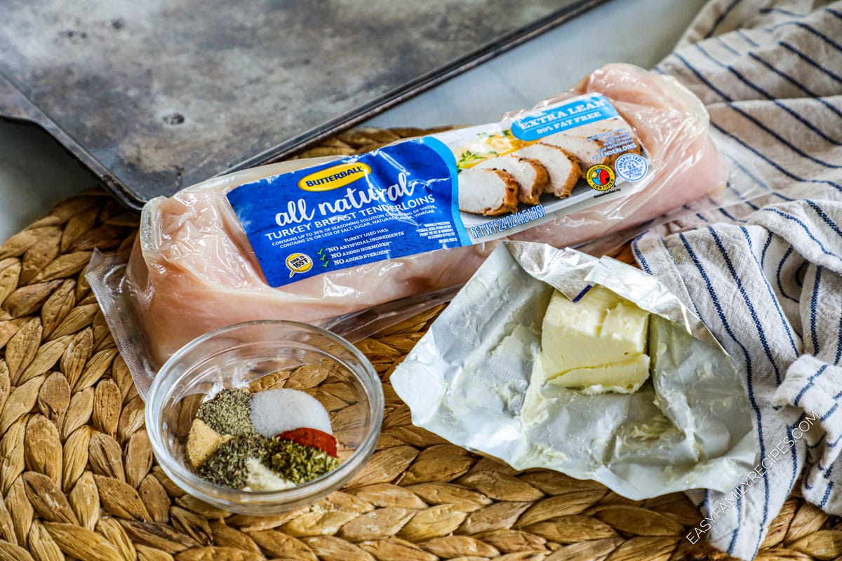 Ingredients are displayed on a counter. They include a package of turkey tenderloin, seasonings and butter. 