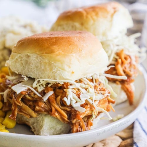 two shredded bbq chicken sliders on a plate.