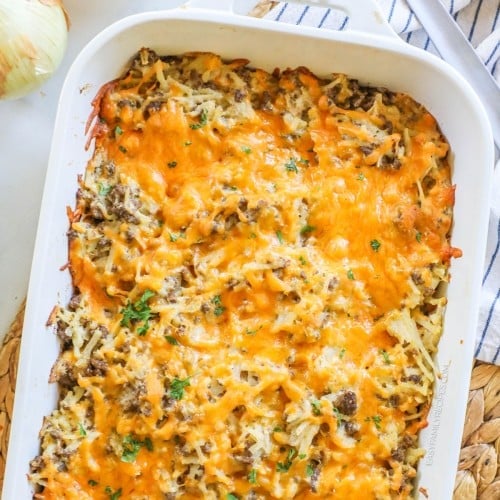 Overhead view of cheesy ground beef hashbrown casserole in baking dish