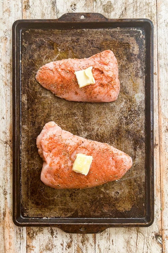 How to make Turkey Tenderloin in the oven step 4: place turkey tenderloin on a baking sheet and put a pat of butter on top of each tenderloin.