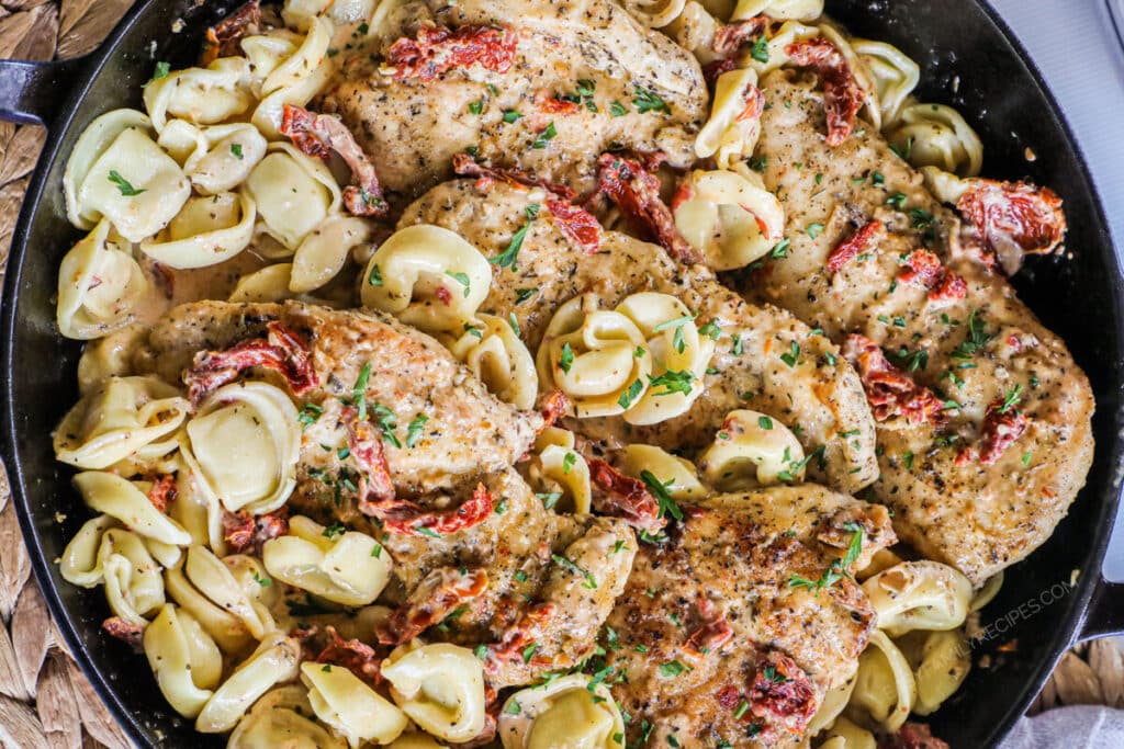 Close up of Marry me chicken and tortellini dish prepared.