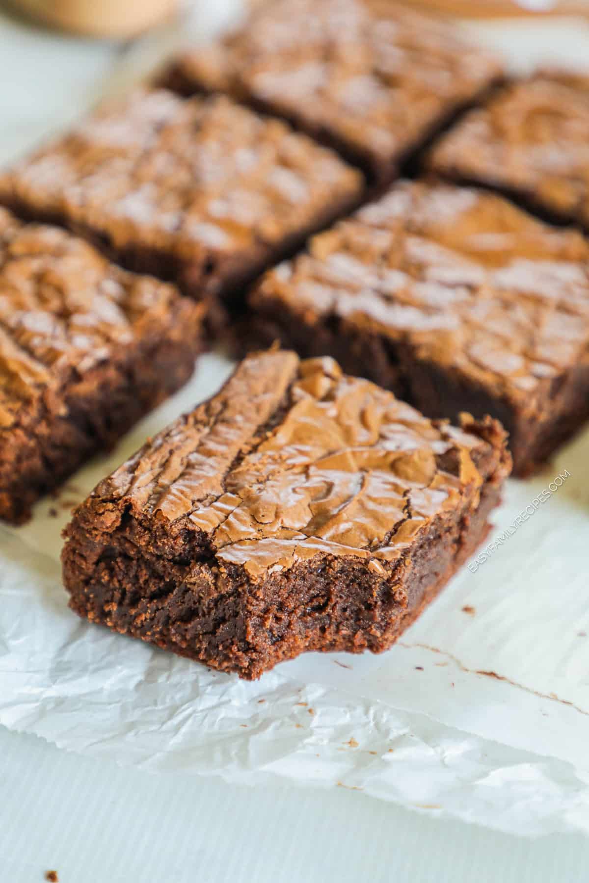 nutella brownies cut into squares and lined on a piece of parchment paper.