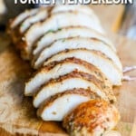 Sliced turkey tenderloin on a cutting board.