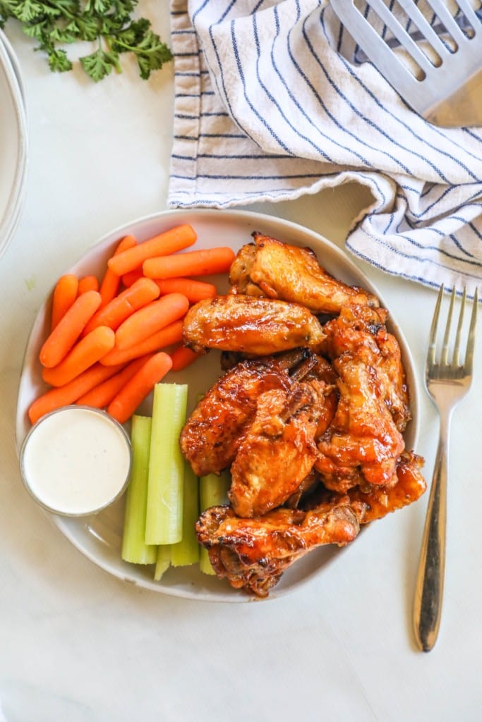 Chicken wings served with celery and carrot sticks