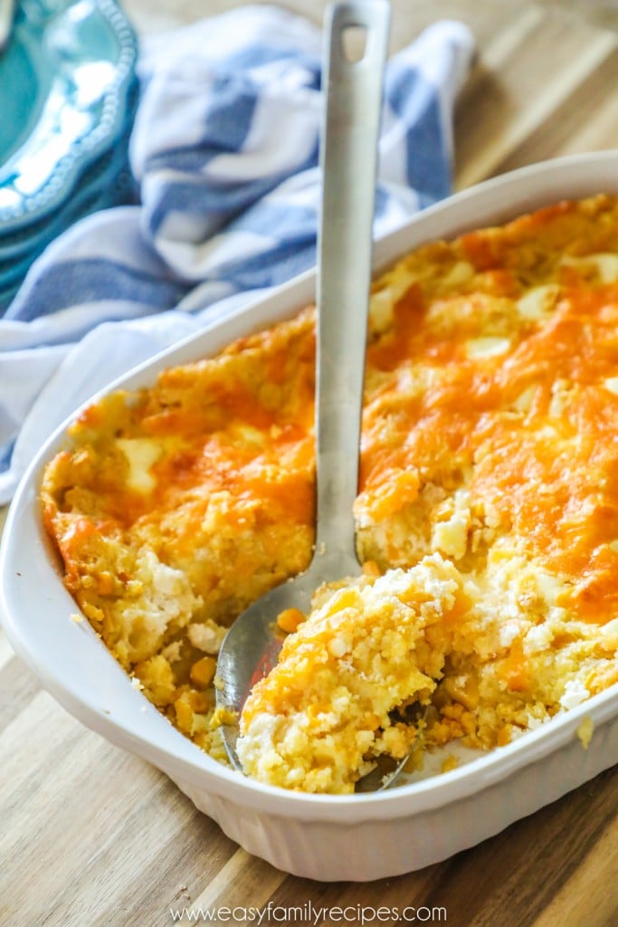 Scooping a spoonful of Jiffy Corn Casserole to serve with wings