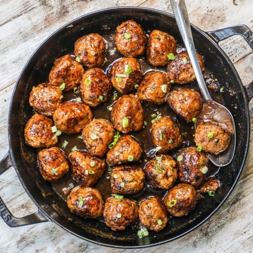 Overhead view of firecracker chicken meatballs in skillet