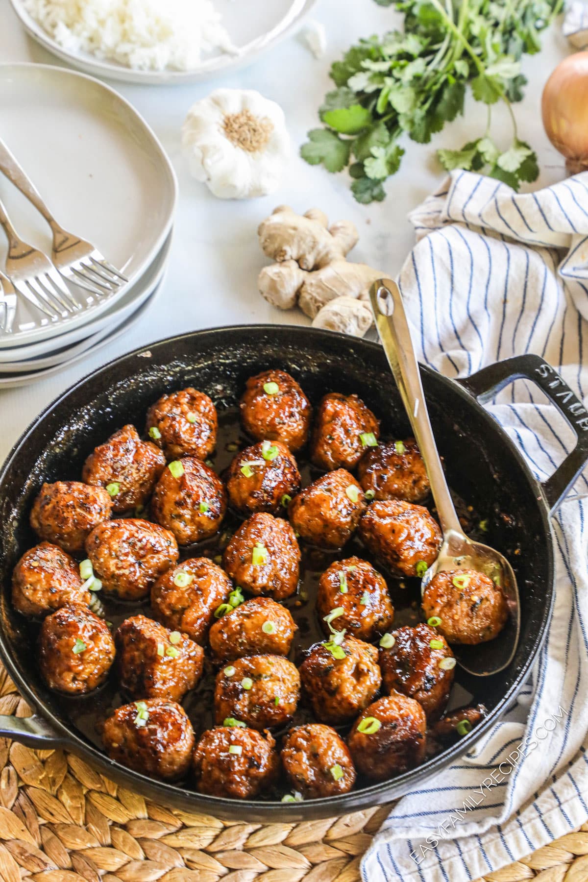 Skillet of firecracker meatballs garnished with green onions