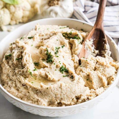 a large bowl filled with roasted cauliflower mash.