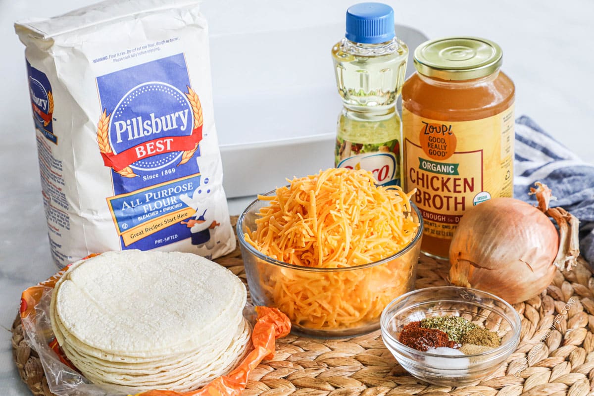 Ingredients for recipe: flour, corn tortillas, oil, shredded cheese, chicken broth, onion, spices. 