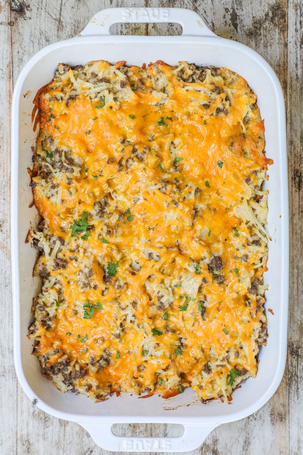 How to make ground beef hashbrown casserole: 4) bake in casserole dish with cheese on top