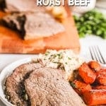 Slow cooker roast beef on plate with carrots and mashed potatoes