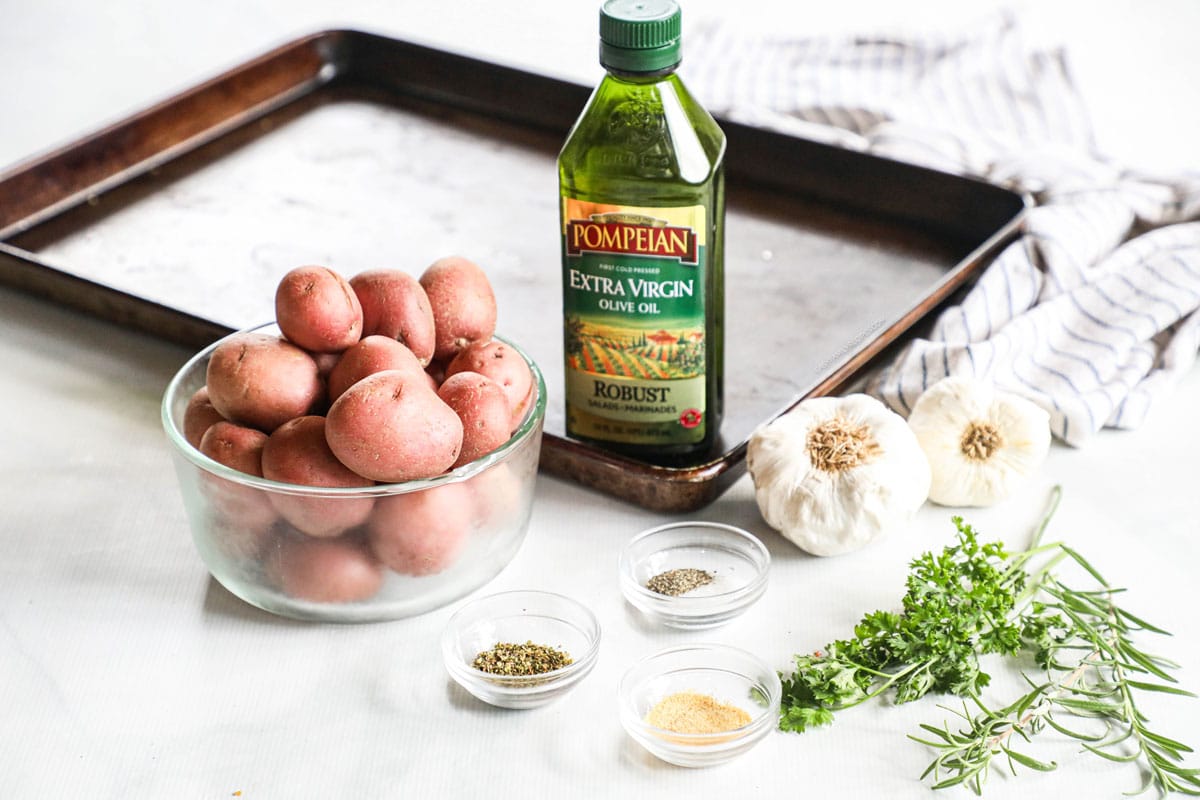 Ingredients for making Herb Roasted Potatoes in the oven-  red potatoes, herbs, olive oil, seasoning