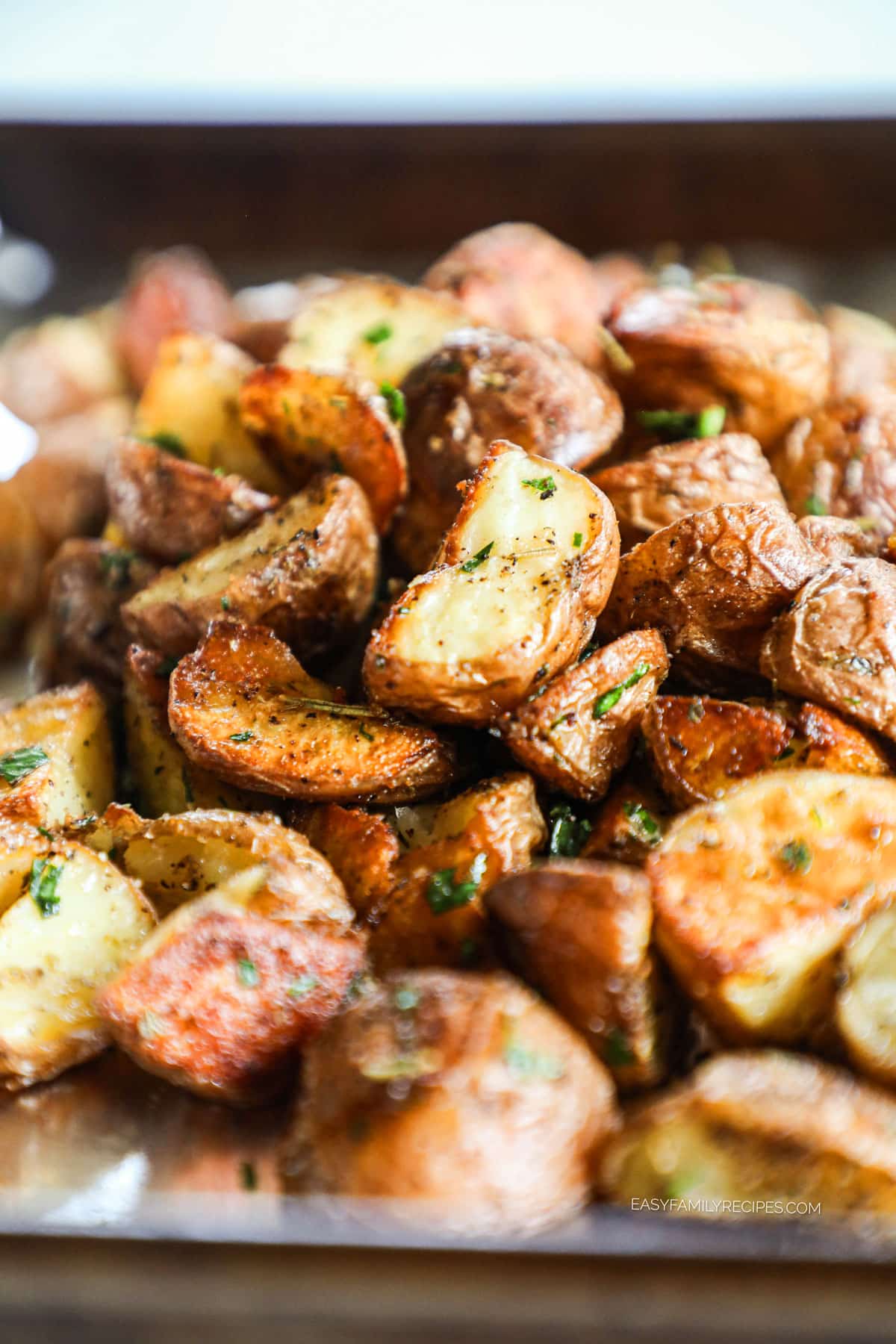 Roasted Red Potatoes on a baking sheet tossed with fresh herbs