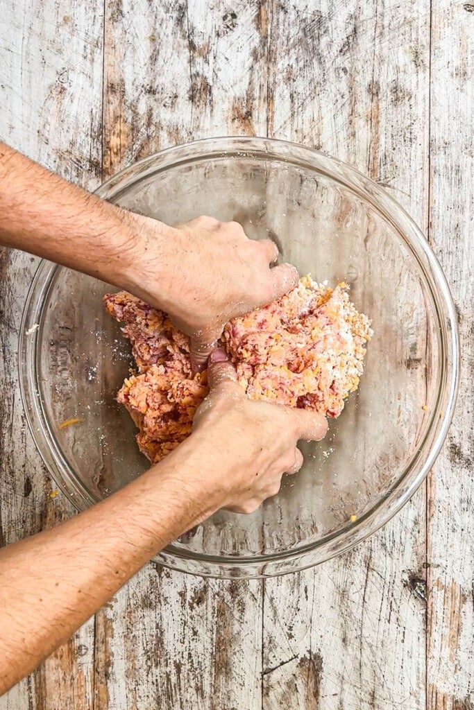 How to make cheddar bay sausage balls step 2: use your hands to mix until it comes together.