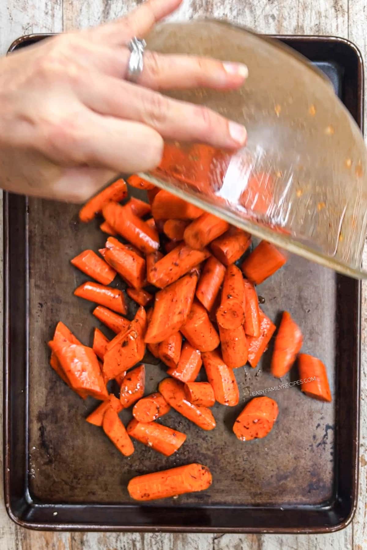 step 3 of maple glazed carrots. toss carrots to coat with ingredients and added to sheet pan