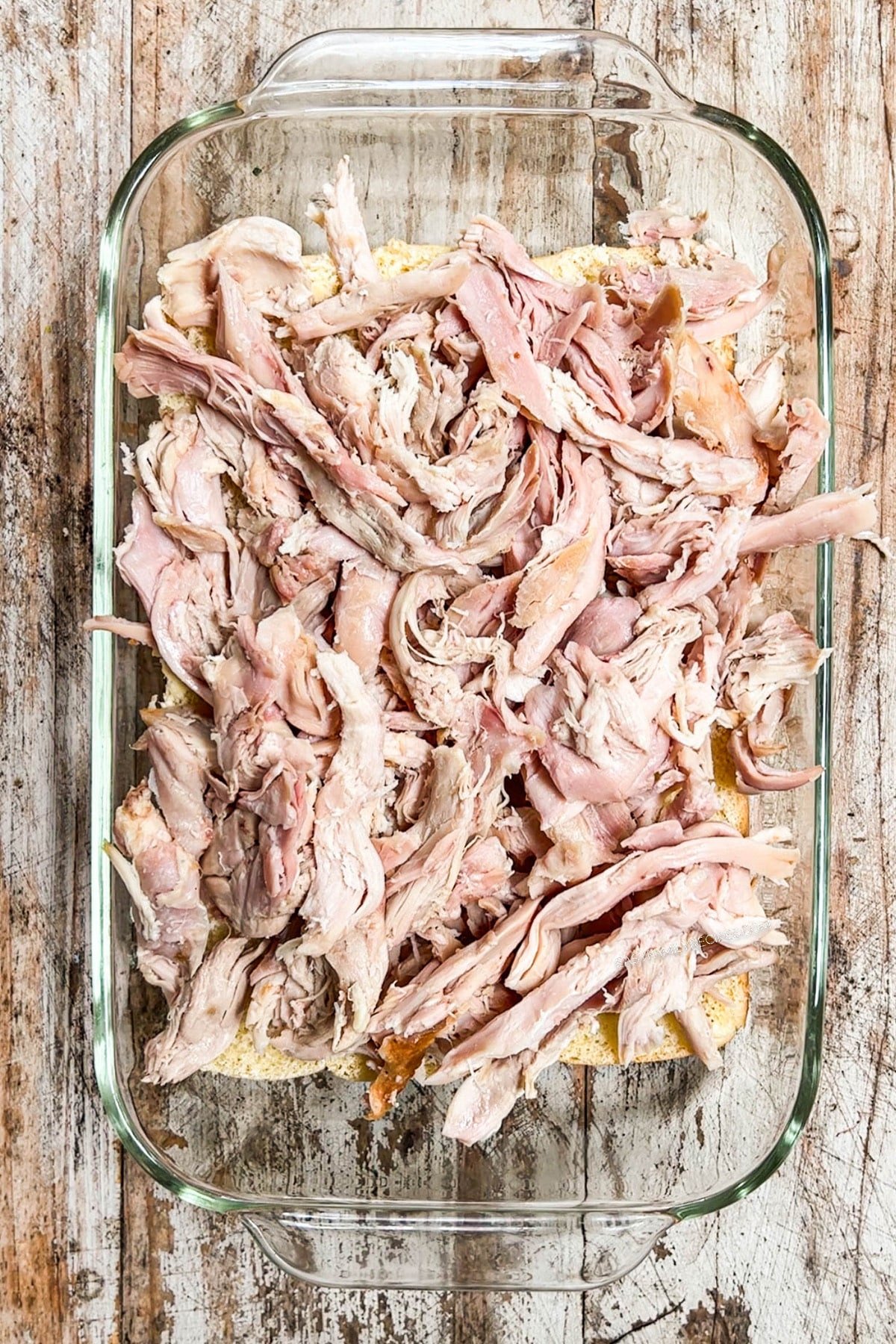 pan of shredded turkey on top of rolls