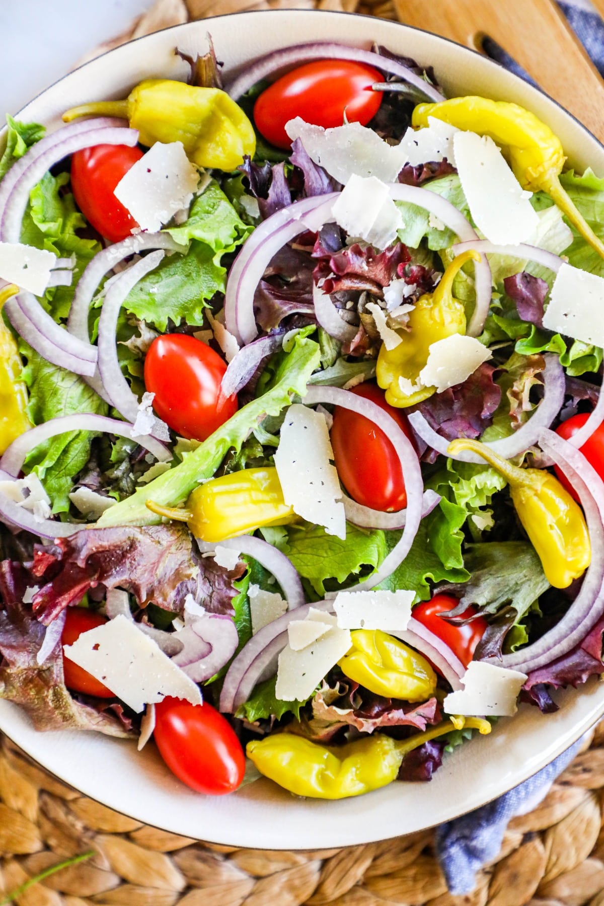 An image of a house salad with onions, tomatoes and lettuce
