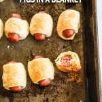 Overhead view of pigs in a blanket on sheet pan