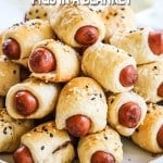 Crescent roll pigs in a blanket stacked on plate