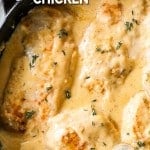 Overhead view of smothered chicken breast in skillet with gravy