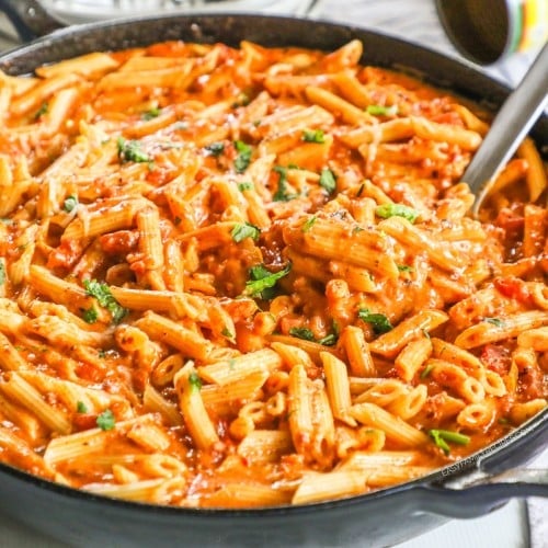 Creamy chorizo pasta in skillet with cilantro