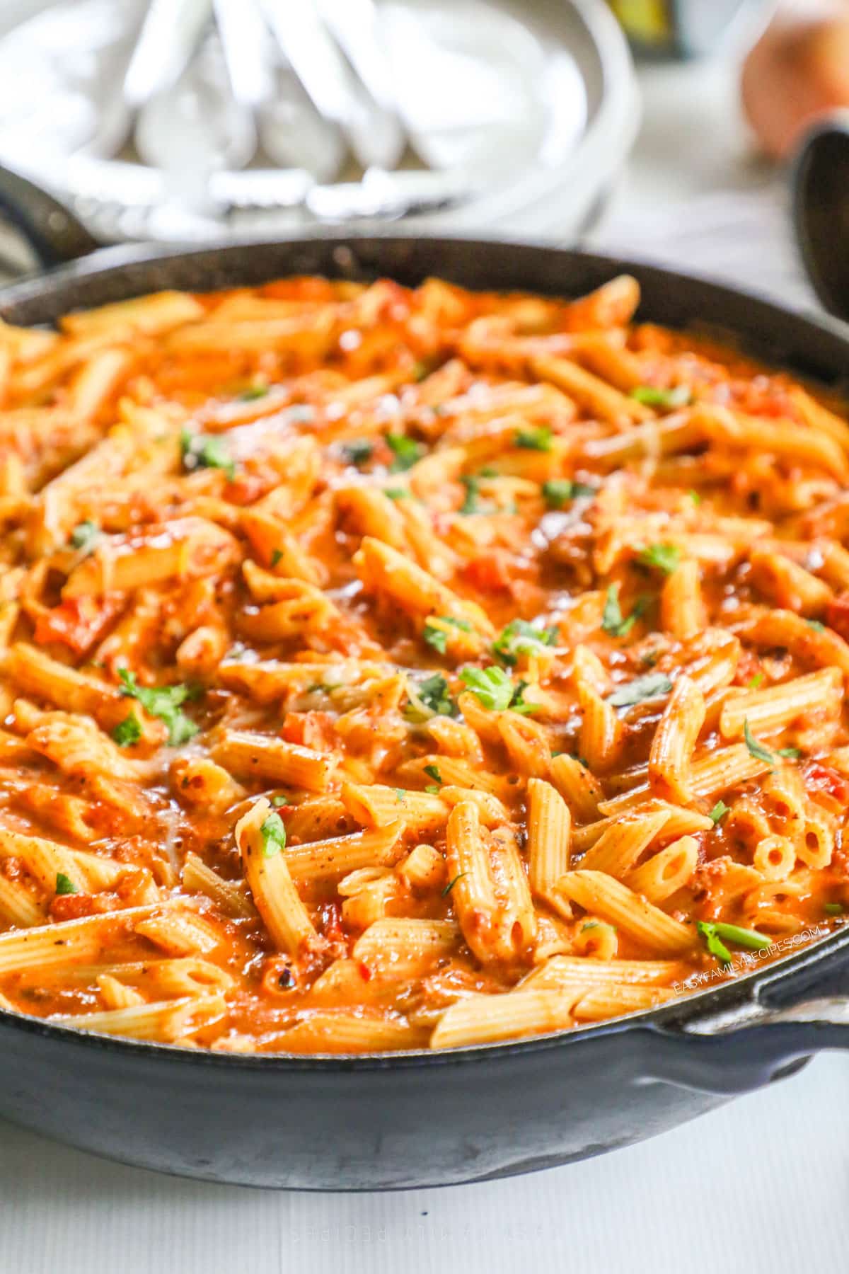 Creamy chorizo pasta in skillet with cilantro