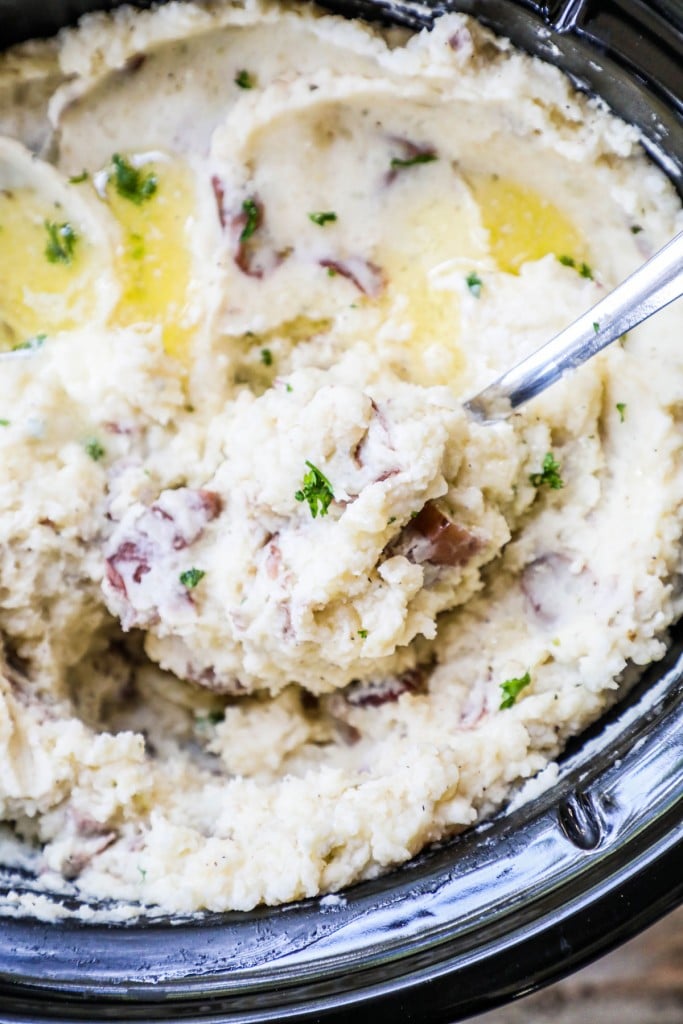 Mashed Potatoes in a crockpot covered with Butter