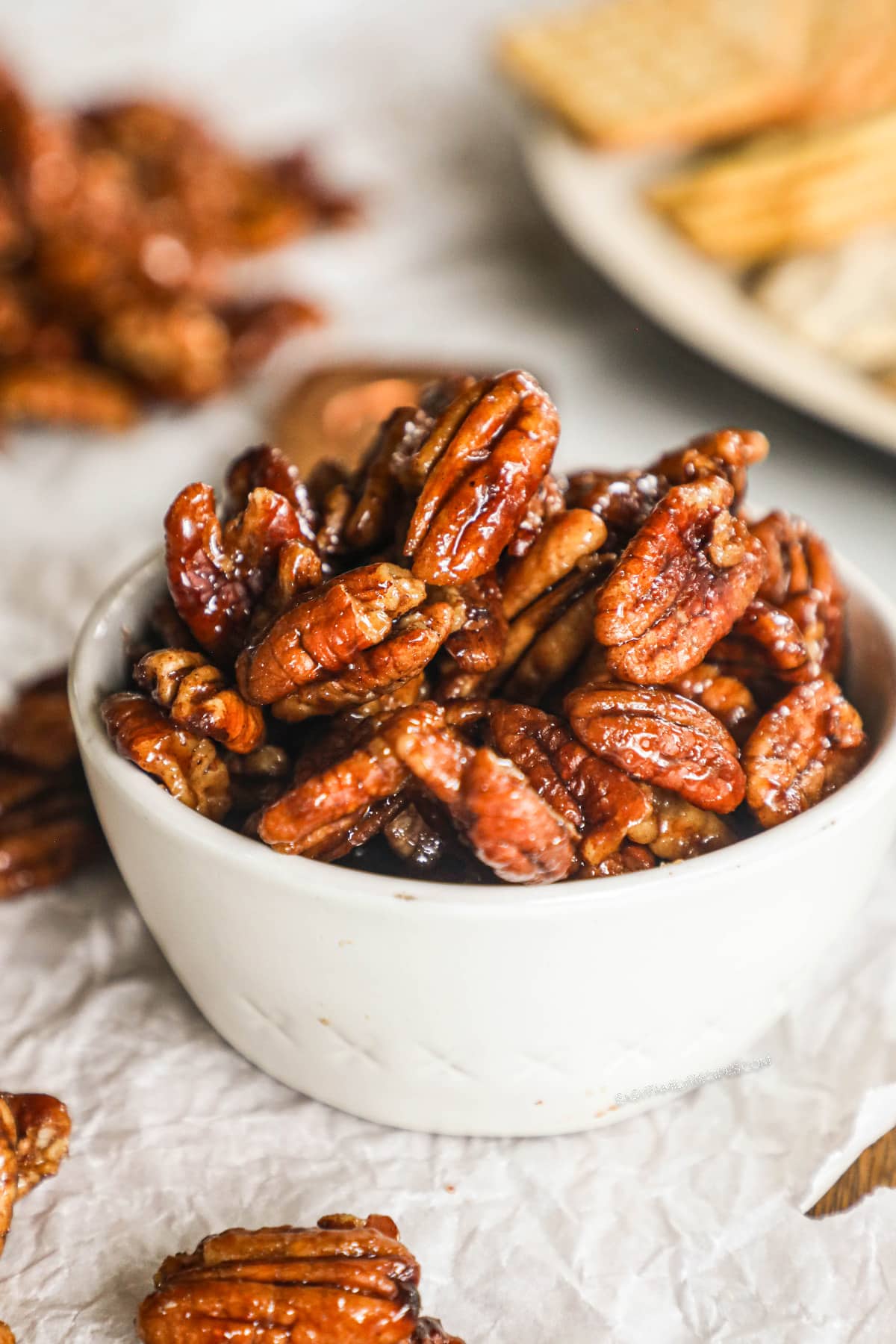 a bowl filled with sweet and spicy pecans.