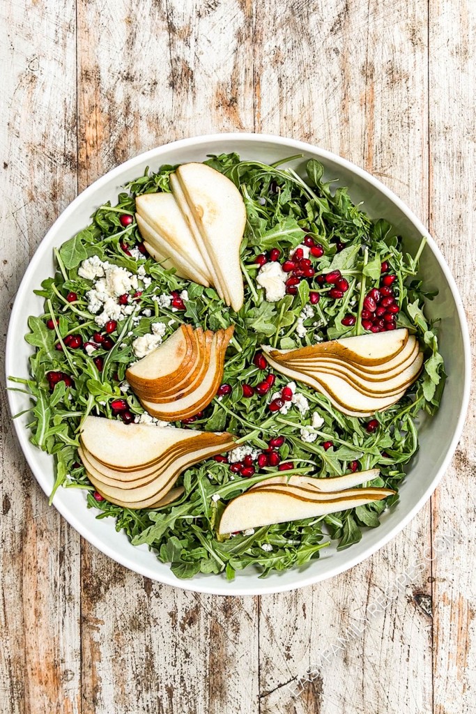 above image of pears added to a salad.