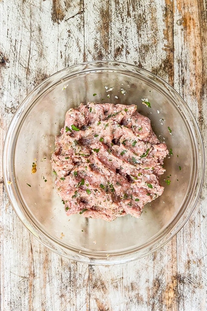 Ground turkey patty mixture in glass bowl