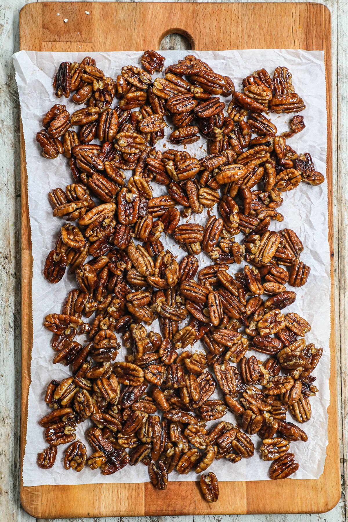 pecans cooling on a piece of parchment paper from above.