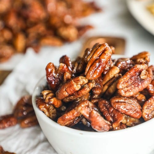 a bowl filled with sweet and spicy pecans.