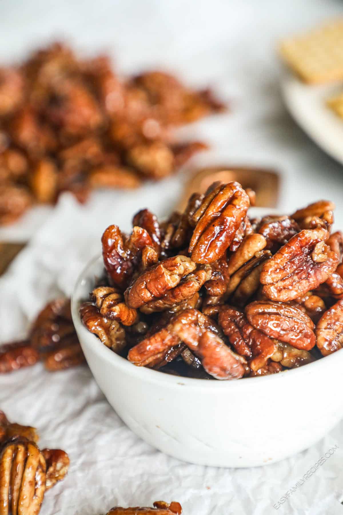 a bowl filled with sweet and spicy pecans. 