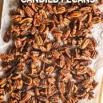 overhead image of sweet and spicy pecans spread out on a piece of parchment paper.