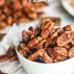 a bowl filled with sweet and spicy pecans.