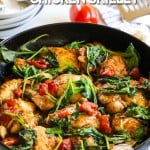 Skillet of Tuscan chicken thighs with spinach and tomatoes