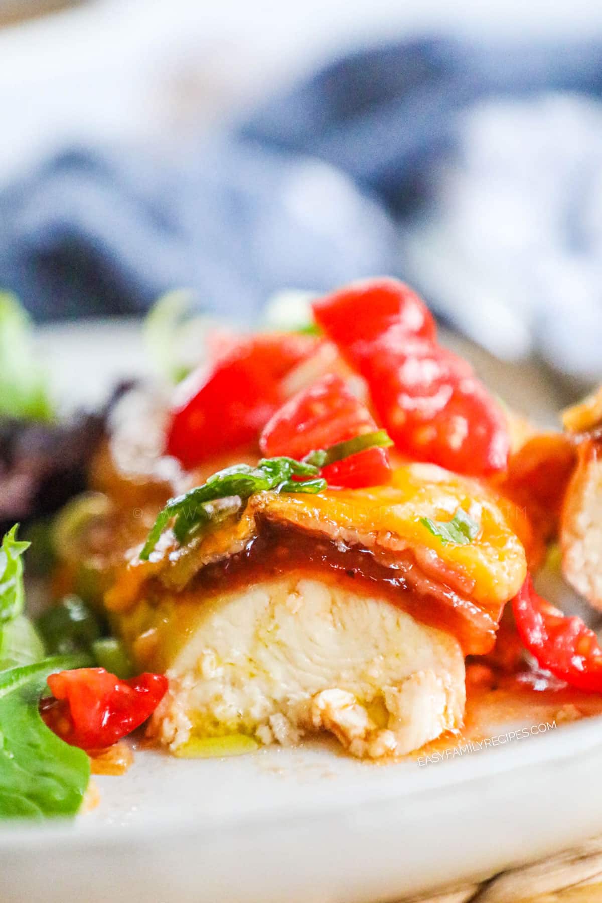 Monterey Chicken Recipe prepared and plated with a bite cut out of it to show tender juicy chicken