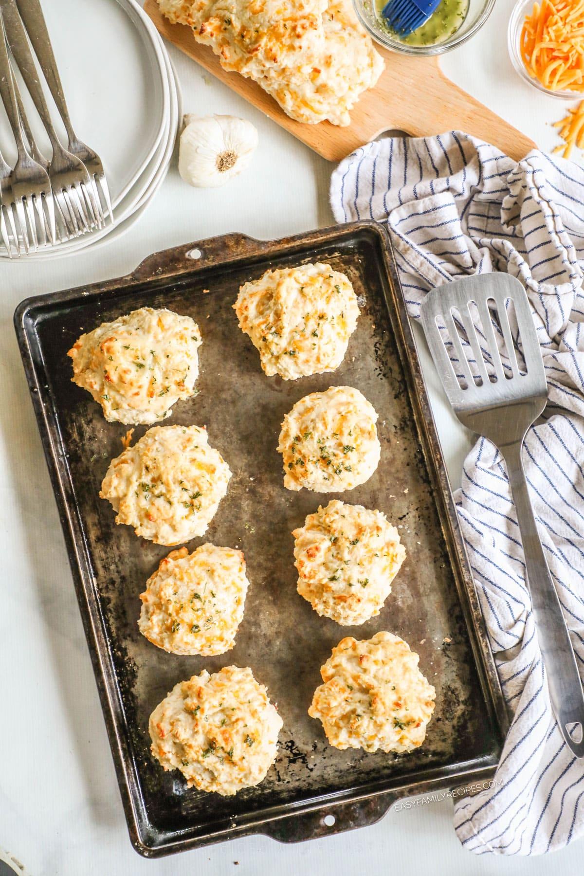above image of homemade red lobster cheddar bay biscuits lined on a baking sheet. 