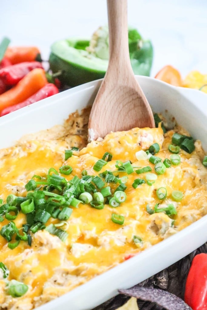 Spooning out cajun chicken dip made with diced chicken