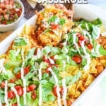 Scooping baked chicken taco casserole from casserole dish